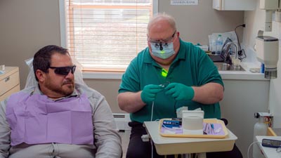 Dr. Monsman speaking with patient about dental restorations